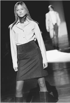Kenneth Cole, fall 2001 collection: napa leather shirt, pinstripe skirt, wide suede belt, and wrap choke collar. © AP/Wide World Photos.