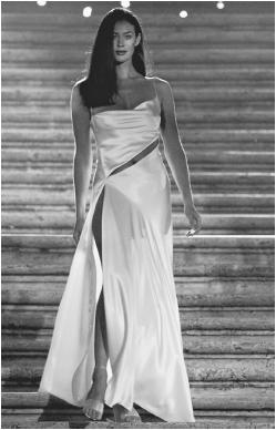 Satin evening gown by Genny Holding SpA, modeled on the Spanish Steps in Rome during the "Donna sotto le stelle" ("Women Under the Stars") fashion gala, 1999. © AP/Wide World Photos.