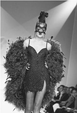 Bob Mackie, fall 2001 "Foreign Intrigue" collection: beaded slip top minidress with an ostrich coat. © AP/Wide World Photos.