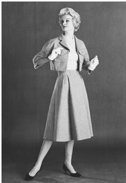Mainbocher, spring 1958 collection: wool suit with a halter top of lace over shantung. © Bettmann/CORBIS.