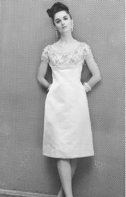 Adele Simpson , fall 1964 collection: satin princess dress. © AP/Wide World Photos.
